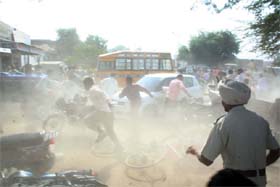Cops chasing away the students who went on rampage protesting against private bus transporters