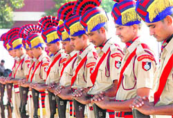 Jawans pay homage to police and paramilitary martyrs by lowering their arms during the Police Commemoration Day parade at the police station, Sector 17, Chandigarh, on Wednesday. 