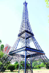 MID-AIR TRAFFIC CONTROL: A no-parking barricade of the traffic police is seen on a replica of the Eiffel Tower near the Natural History Museum at Sector 10, Chandigarh, on Wednesday.