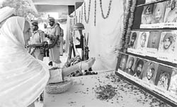 An elderly woman pays floral tributes to martyrs in Mohali on Wednesday
