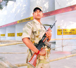  A security persomnnel stands guard at a counting centre  in Gurgaon. 