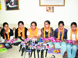 Girls of Shah Satnam Girls Senior Secondary School, Sirsa, with their teacher Sunita Khurana in Sirsa on Wednesday after their return from NASA. 
