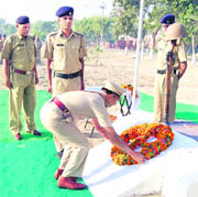 A police officer lays a wreath at a memorial in Sirsa on Wednesday. 