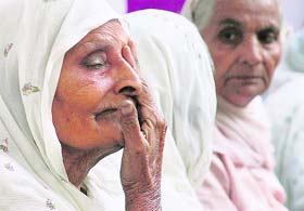 An old woman breaks down during the Police Commemoration Day function after cops paid tributes to her martyred son