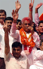 Congress candidate from the Badshahpur constituency Rao Dharam Pal shows the victory sign in Gurgaon on Thursday.