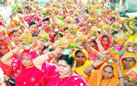 Women carry kalash on their heads as part of the Chhath festival in Haridwar on Wednesday.