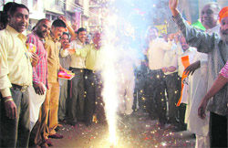 Congress workers celebrate the victory of the party in three states by bursting crackers in Ludhiana 