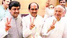 Maharashtra Chief Minister Ashok Chavan flashes victory sign with Union Minister and party leader Sushil Kumar Shinde and MPCC president Manikrao Thackeray in Mumbai on Thursday. 