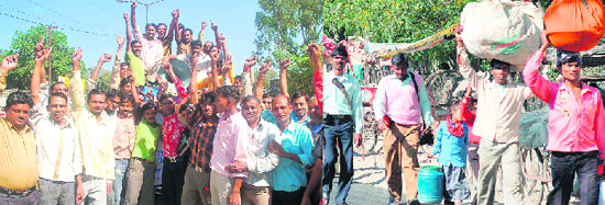 Autorickshaw drivers in Haridwar protest on the streets; and (right) commuters walk to their destinations on foot on Friday.
