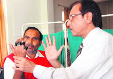   Dr Atul Shah from JJ Hospital, Mumbai, examines the grip of a leprosy patient at the camp in Dehradun on Friday. 
