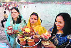 Women perform Chhat puja at the Sector 42 lake in Chandigarh on Saturday.