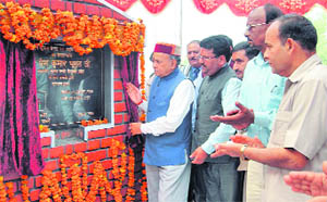 Chief Minister PK Dhumal laying a foundation stone of a tourist information centre at Nadaun on Saturday.