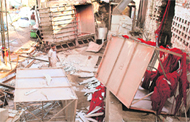 A worker walks through the rubble in the dyeing unit after a blast 