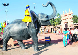 An elephant figure salutes the visitors