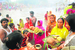 People offer prayers at the Sirhind Canal in Bathinda on the occasion of Chhat Puja