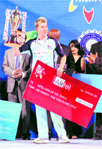 NSW Blues Brett Lee poses after being presented with the Man of the Series and Man of the match awards at the end of Champions League Twenty20 final on Friday.