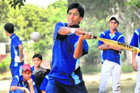 A player hits a ball during a softball match at the National School Games in Chandigarh on Sunday. 