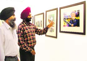 Major Amarjeet Singh Batth shows photos clicked by him at Gallery Artmosphere in Ludhiana