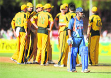 Australian cricketers celebrate the wicket of Suresh Raina (unseen) as Indian captain Mahendra Singh Dhoni walks, on Sunday