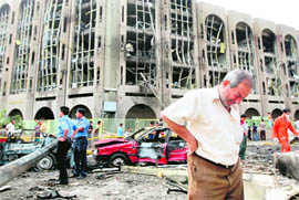 An Iraqi weeps as he walks away from the ministries of justice and labour following a suicide bombing on Sunday.  AFP