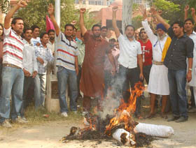 Residents of Sadhana village burn an effigy of Congress MLA Gurpreet Singh Kangar in Bathinda on Monday. 