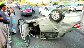 A car overturned following a collision with another car near the rotary on the road separating Sectors 32 and 46 in Chandigarh on Monday.