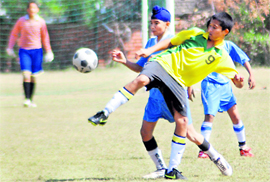 Players vie for the ball during a match at the Football Stadium, Sector 17, in Chandigarh on Monday.