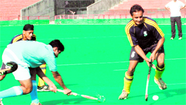 Players of PU Campus and ILR Government College, Dhudike, in action during a match held at the Hockey Stadium,Sector 42, in Chandigarh on Monday.