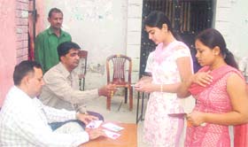 Students identity cards being checked at SMJN College by disciplinary officer SK Batra