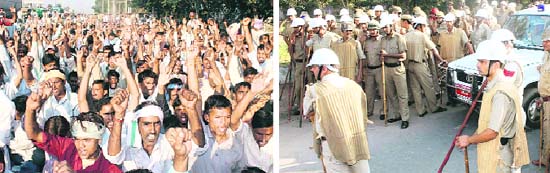 Industrial workers stage a dharna outside the RICO auto company in Gurgaon on Monday; and (right) police personnel stand guard outside the company