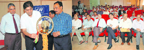 Raman Saluja, a former chairman of the CII Haryana State Council, lights a lamp to inaugurate a conference at the National Dairy Research Institute, Karnal; and (right) a view of the attentive participants.