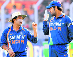 Sachin Tendulkar and MS Dhoni during the first ODI at Vadodara on Sunday.