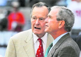 Former US Presidents George HW Bush (left) and George W Bush watch warm-ups before the Houston Texans NFL football game against the San Francisco 49ers in Houston on Sunday.