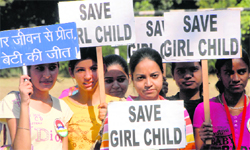 Girls display placards with slogans at a rally on female foeticide in Chandigarh