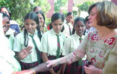 Cherie Blair, wife of former British Prime Minister Tony Blair and president of the Loomba Trust, shakes hands with children at Sanskriti School in New Delhi on Tuesday.