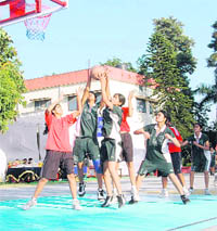 Girls try to score a basket at the The Frank Anthony Memorial Basketball Tournament in Dehradun on Tuesday.