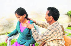 A roadside quack tries to relieve a woman patient of her shoulder pain in Hamirpur.