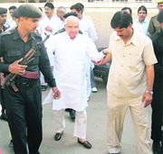 Former Chief Minister Bhajan Lal being helped towards his vehicle in Sirsa on Tuesday.