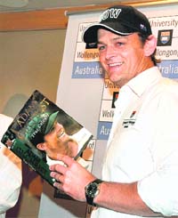 Former Australian skipper Adam Gilchrist displays his autobiography True Colours in Mumbai