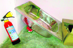 A fire extinguisher lies unused at a government school in Khamano