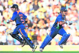 Gautam Gambhir (L) and Mahendra Singh Dhoni run between the wickets during the second One Day International between India and Australia at Jamtha Stadium in Nagpur