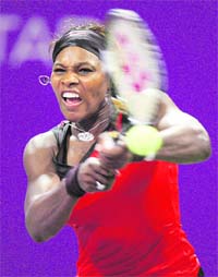 Serena Williams returns a ball to Svetlana Kuznetsova during their singles match at the WTA Tennis Championships, in Doha