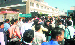 Photo journalists come out of the venue of a function at a factory in Haridwar where the Chief Minister was the chief guest.
