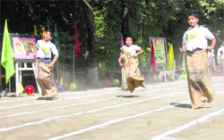 Students participate in a sack race at the annual sports day of Brightlands School in Dehradun 