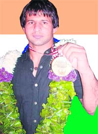 Ramesh Gulia shows off his bronze medal won in the recently concluded World Wrestling Championship