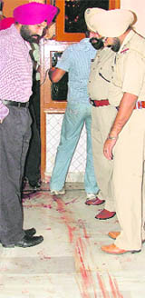 Police officials at the site of the crime in Ludhiana on Thursday.