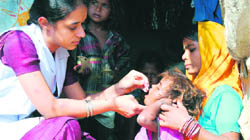 A health worker administers polio drops to a child in Ludhiana.