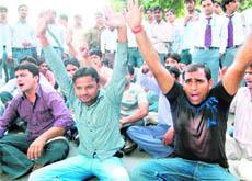 Gurukul Kangri University students protest on the national highway demanding the construction of a bus stop near the University Engineering College.
