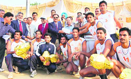 The ONGC volleyball team with the trophy in Dehradun on Friday.