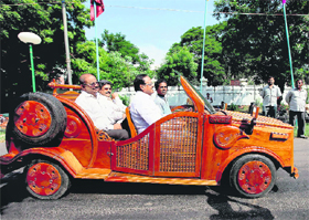 State Minister for Rural Industries Pongalur N Palanisamy drives a modified wooden car during the All India Handicrafts Sourcing Show in Chennai on Friday. 